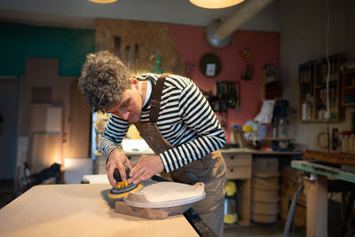 Side view of young man working at home