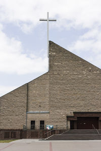 Low angle view of cross against sky