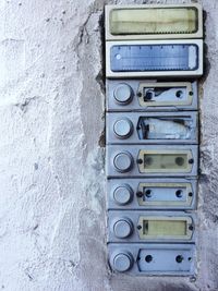 Close-up of old bell nameplate on wall