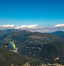 Scenic view of mountains against blue sky