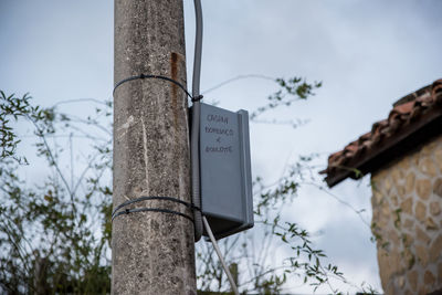 Low angle view of text on tree against sky