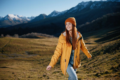 Portrait of young woman standing on mountain