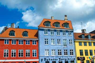 Buildings in town against sky