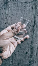 High angle view of person hand holding glass