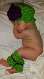 High angle view of cropped hand holding green leaves