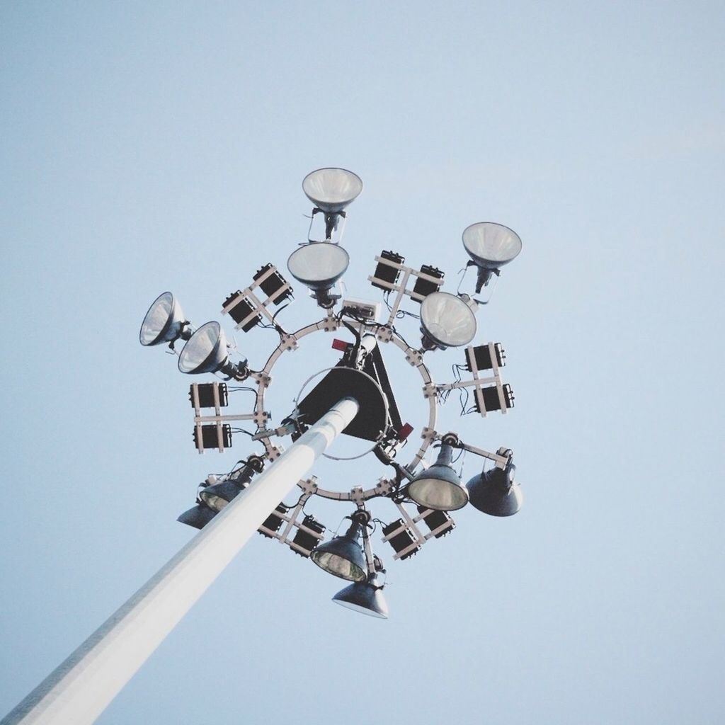 low angle view, clear sky, copy space, blue, built structure, architecture, street light, communication, day, lighting equipment, no people, outdoors, sky, building exterior, travel, high section, sculpture, technology, tall - high, famous place