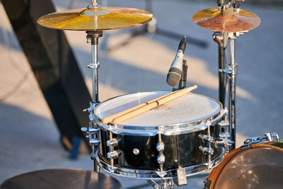 Drum kit at outdoor rock party, drumsticks on tom-tom drum. drum set with drum sticks