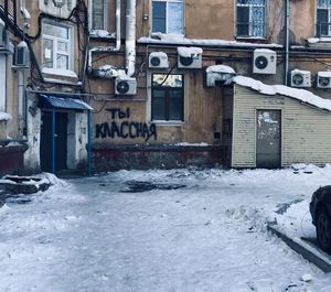 Road by buildings in city during winter