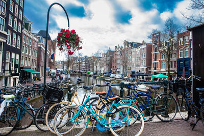 Bicycles parked on street against buildings in city