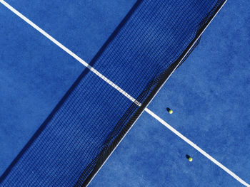 Aerial top view of a blue paddle tennis court