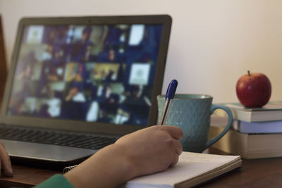 Young woman taking an online workshop at home. e-learning concept