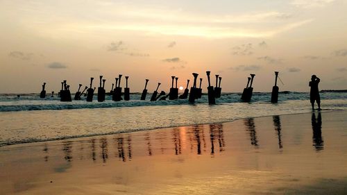 Silhouette of wooden objects in sea