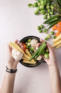 Midsection of woman holding vegetables