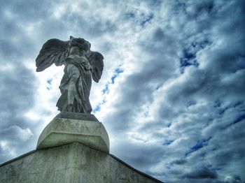 Low angle view of statue against cloudy sky