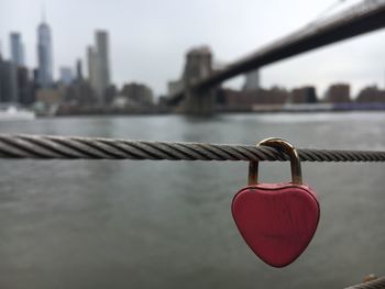 Close-up of padlocks on bridge over river