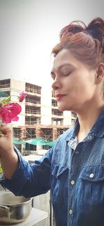 Portrait of beautiful woman holding flower
