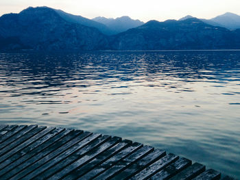 Close-up of rippled lake against mountain range