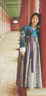 Portrait of a smiling young woman standing outdoors