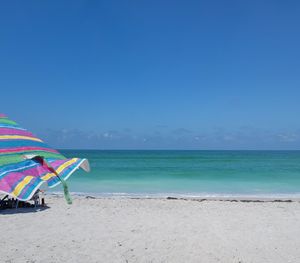 Scenic view of beach against blue sky