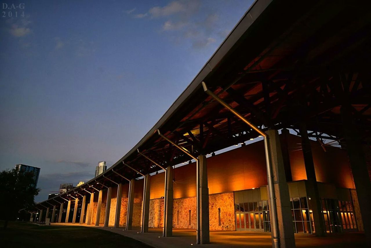 architecture, built structure, building exterior, illuminated, low angle view, night, sky, clear sky, street light, building, outdoors, city, dusk, lighting equipment, no people, house, tree, in a row, architectural column, street