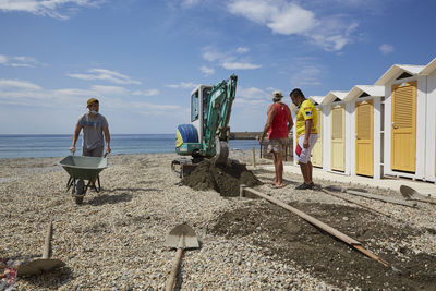 People on beach against sky