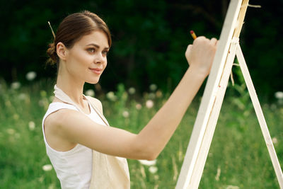 Portrait of young woman holding outdoors