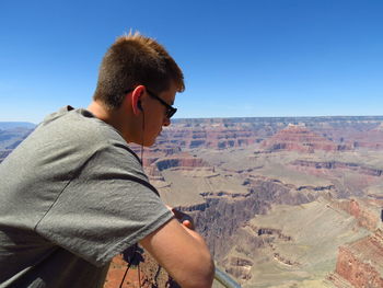 Man on landscape against clear sky