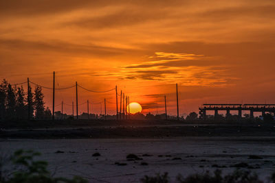 Scenic view of silhouette land against romantic sky at sunset