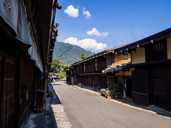 Alley amidst buildings in town against sky