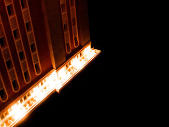 Close-up of illuminated lamp against black background