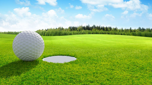 High angle view of golf ball on field against sky