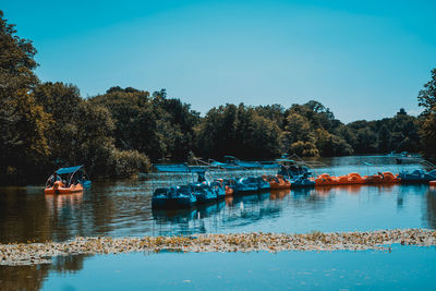 Boats in lake against clear sky