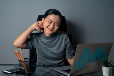 Man using mobile phone while sitting on table