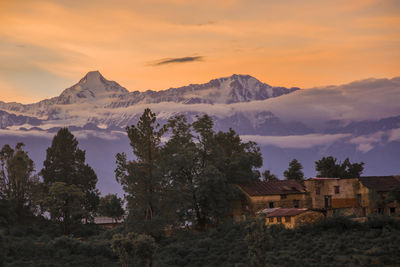 Scenic view of snowcapped mountains against sky during sunset