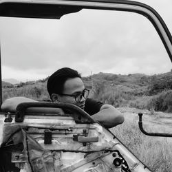 Portrait of man sitting in car