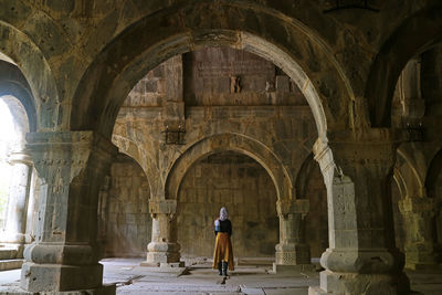 Rear view of woman standing in historic building