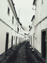 Narrow alley amidst buildings in city