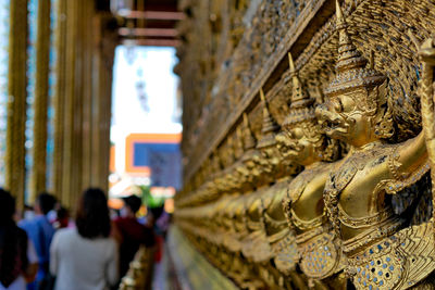 Statue of people in temple outside building