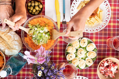 High angle view of woman holding food on table