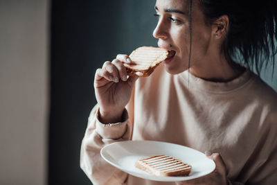 Midsection of woman eating ice cream