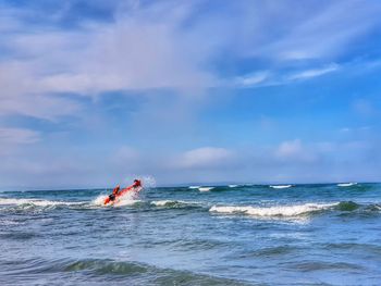 Motor boat in sea against sky