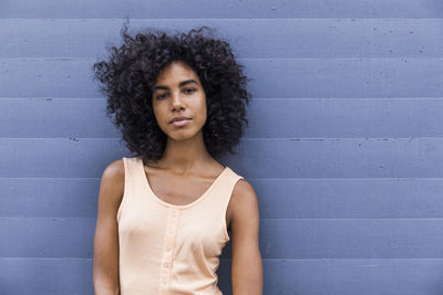 Portrait of young woman with curly black hair