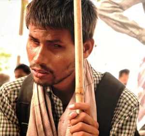 Close-up of blind man holding stick