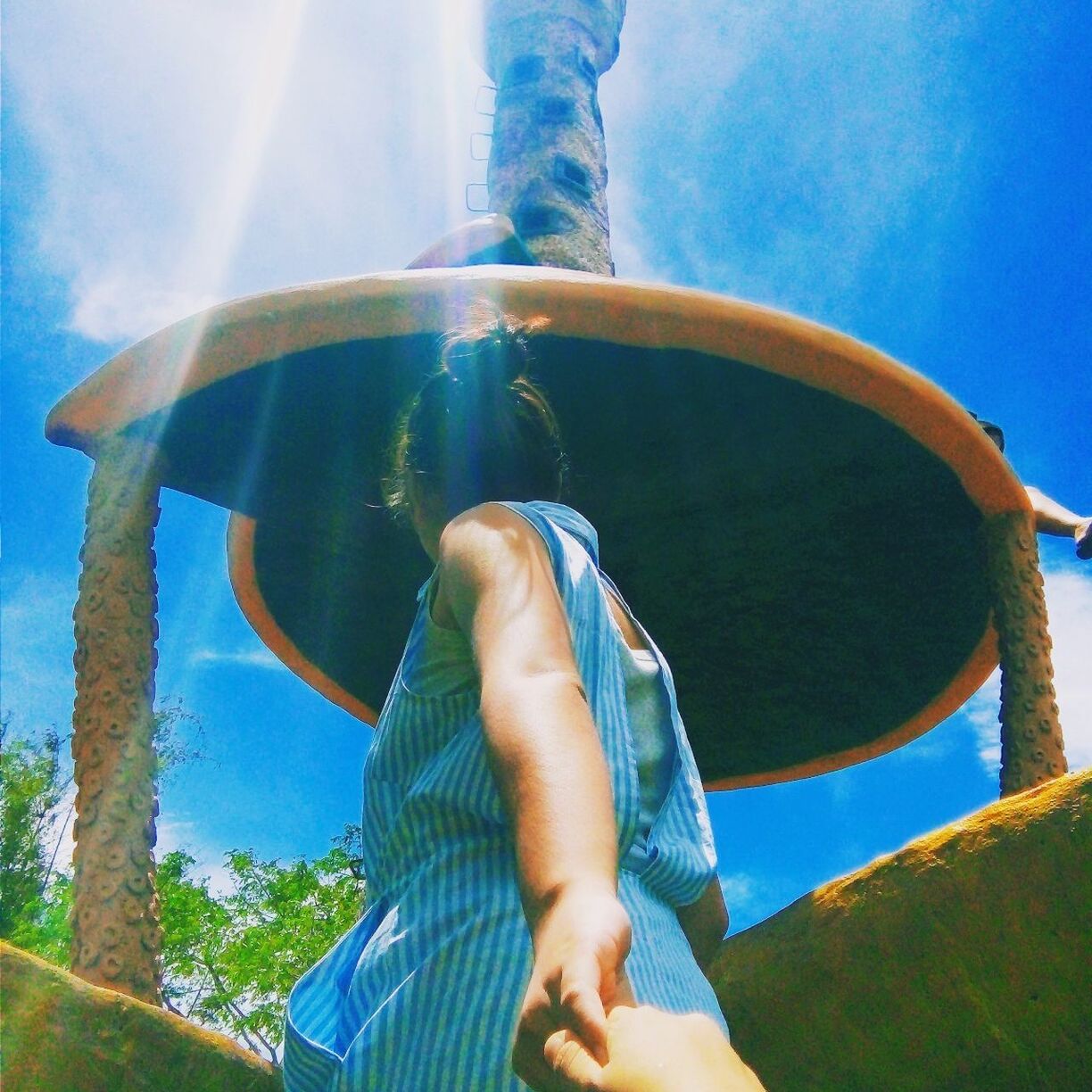 LOW ANGLE VIEW OF PERSON AGAINST CLEAR BLUE SKY