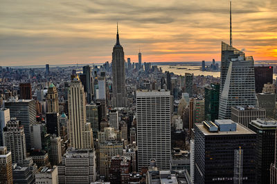 Aerial view of buildings in city during sunset