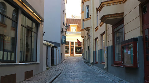 Empty alley amidst buildings in city
