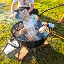 High angle view of people on barbecue grill