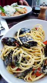 Close-up of noodles with mussels served on table