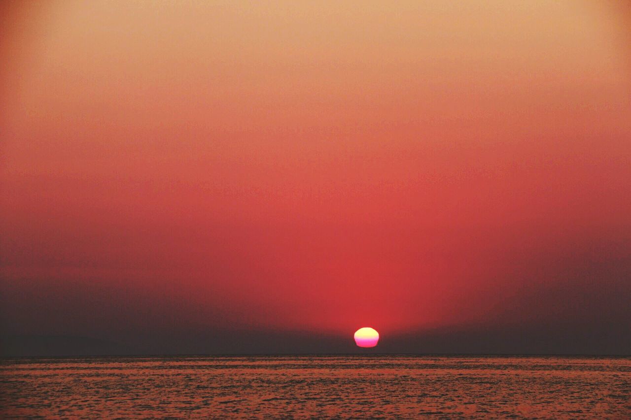 sunset, scenics, tranquil scene, waterfront, sun, tranquility, water, sea, beauty in nature, orange color, idyllic, nature, horizon over water, copy space, red, sky, rippled, clear sky, no people, remote