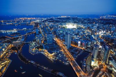 High angle view of illuminated cityscape against sky at dusk